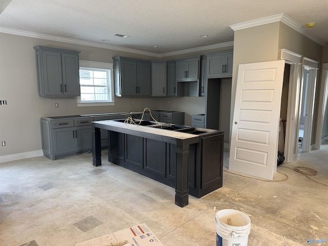 kitchen with gray cabinets, crown molding, and a center island