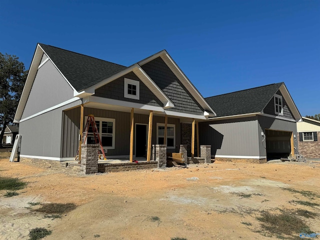 craftsman-style home with a porch and a garage