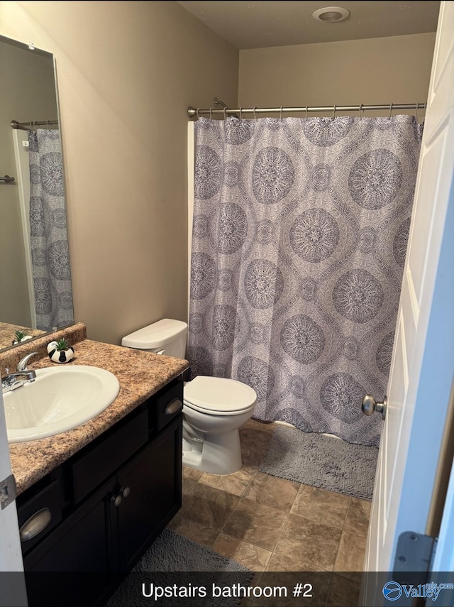 bathroom with toilet and vanity