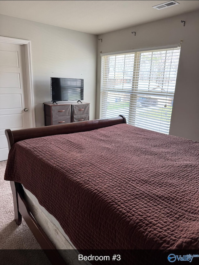 carpeted bedroom with visible vents