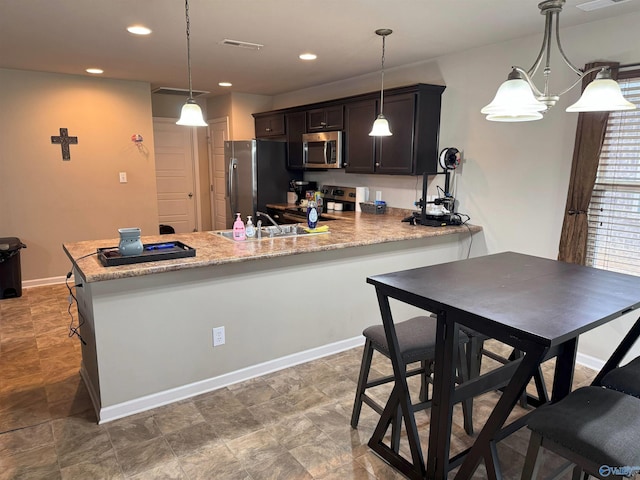 kitchen featuring a peninsula, recessed lighting, visible vents, and appliances with stainless steel finishes