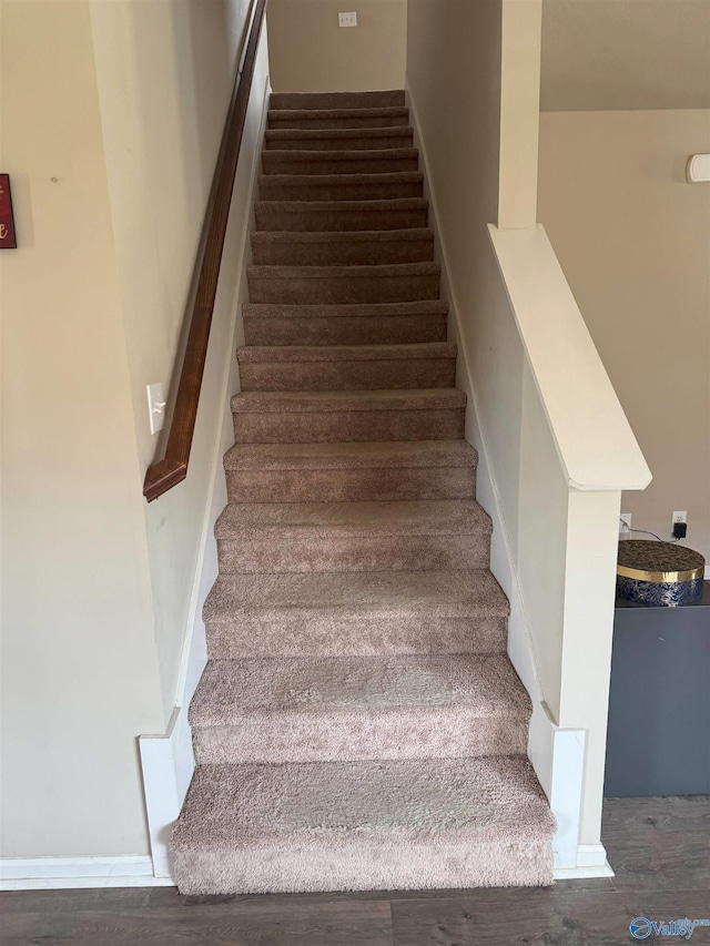 stairway with wood finished floors