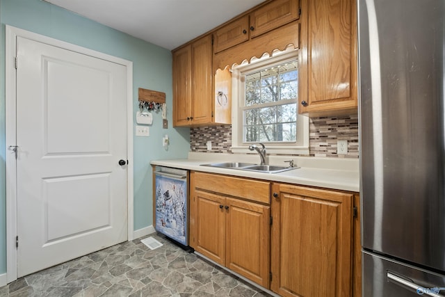 kitchen with decorative backsplash, stainless steel appliances, and sink