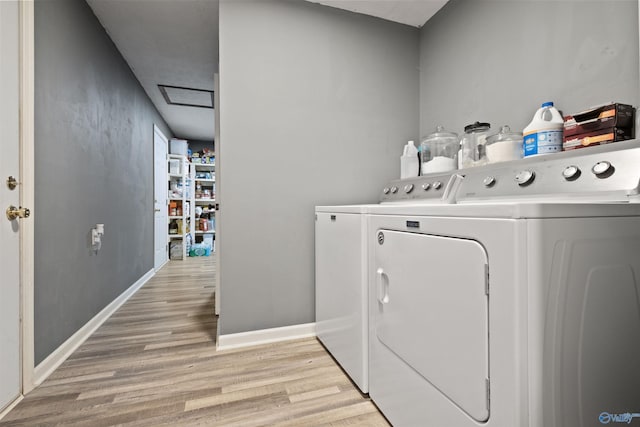 washroom featuring light wood-type flooring and separate washer and dryer