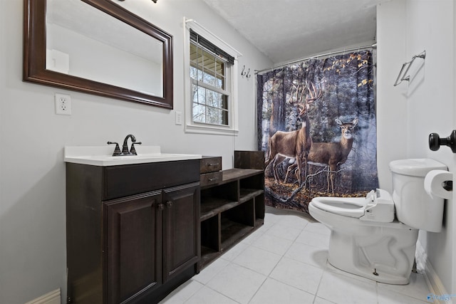 bathroom featuring tile patterned floors, vanity, and toilet