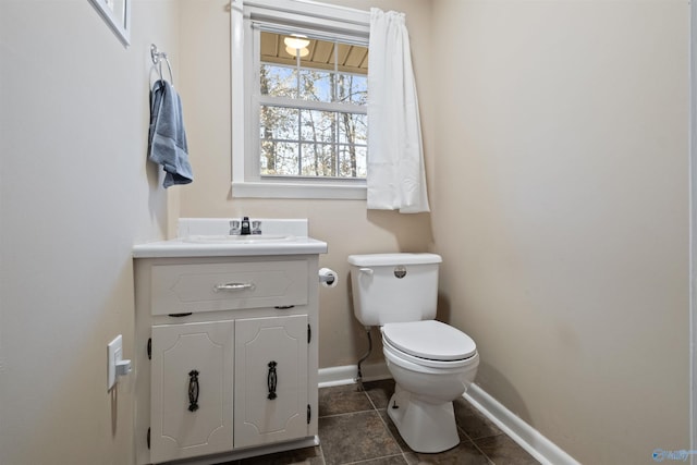 bathroom with tile patterned flooring, vanity, and toilet