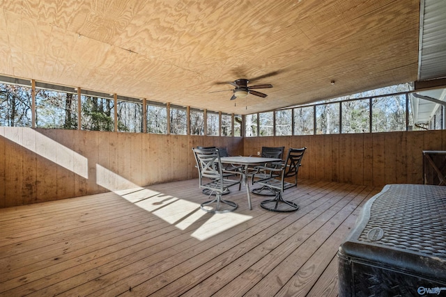 sunroom / solarium with ceiling fan, a healthy amount of sunlight, and vaulted ceiling