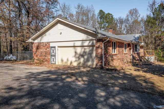 view of front of property with a garage and a deck