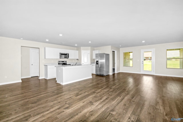 unfurnished living room featuring dark hardwood / wood-style flooring and sink