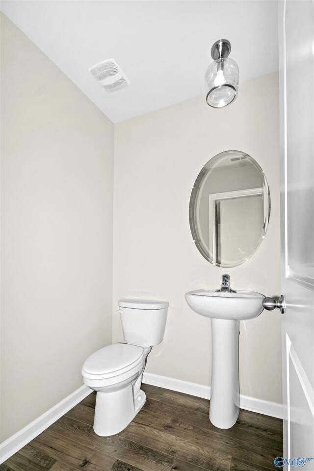 165 Meadowridge Dr, Hazel Green, AL 35750 - bathroom featuring wood finished floors, toilet, and baseboards