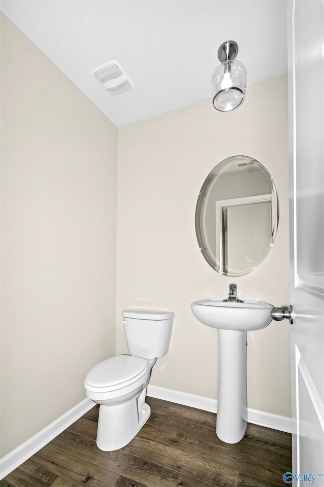 bathroom featuring toilet and hardwood / wood-style flooring