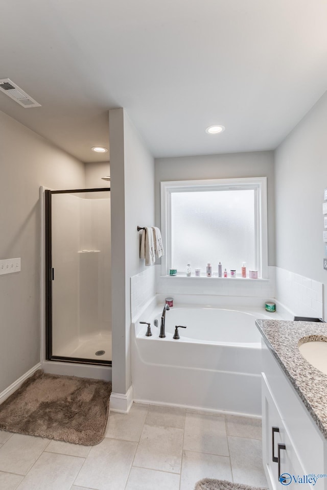 bathroom featuring vanity, separate shower and tub, and tile patterned floors