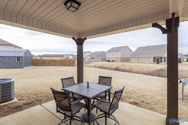 view of patio / terrace featuring central AC and a storage unit