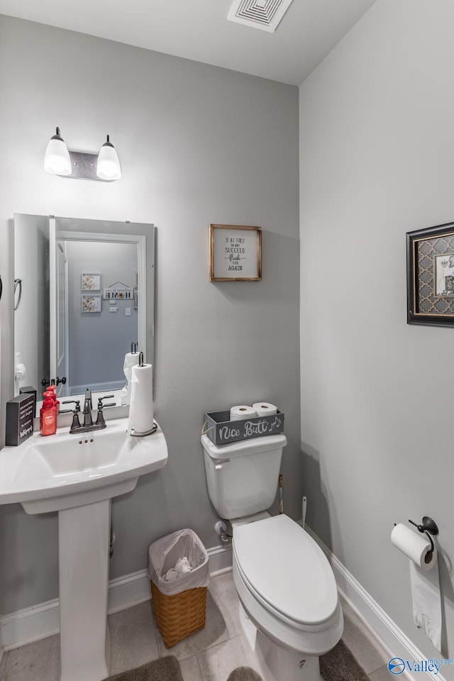 bathroom featuring tile patterned floors, toilet, and sink