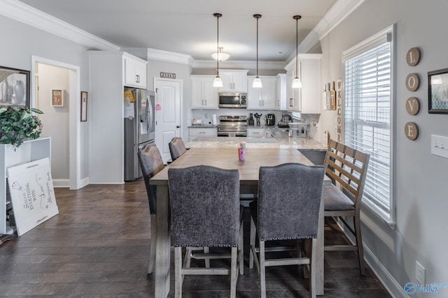 dining space with dark wood-type flooring and ornamental molding