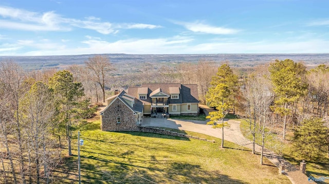 drone / aerial view featuring a wooded view