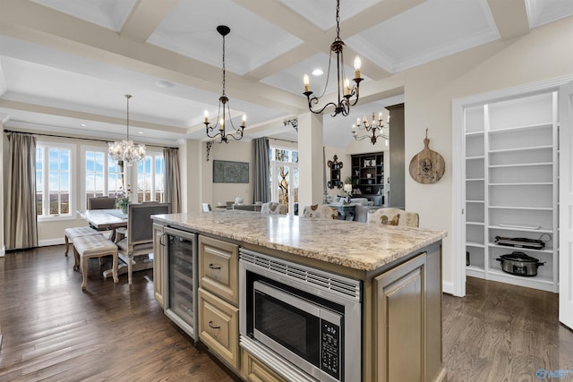 kitchen featuring stainless steel microwave, beamed ceiling, an inviting chandelier, dark wood-style floors, and coffered ceiling