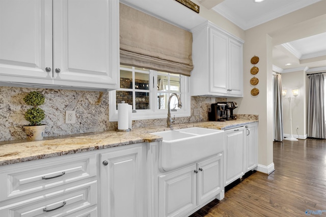 kitchen with a sink, backsplash, wood finished floors, white cabinets, and crown molding