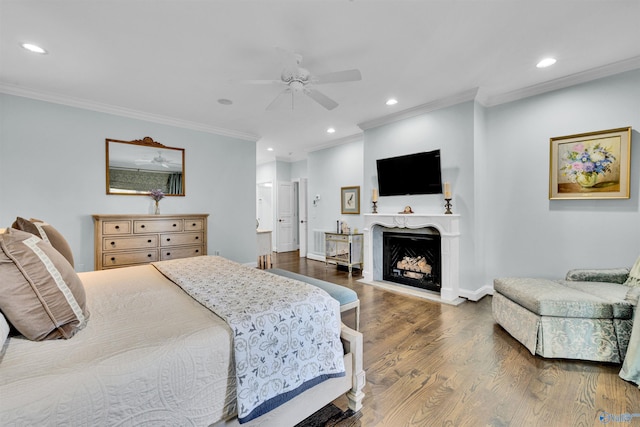 bedroom with recessed lighting, wood finished floors, a fireplace, and ornamental molding