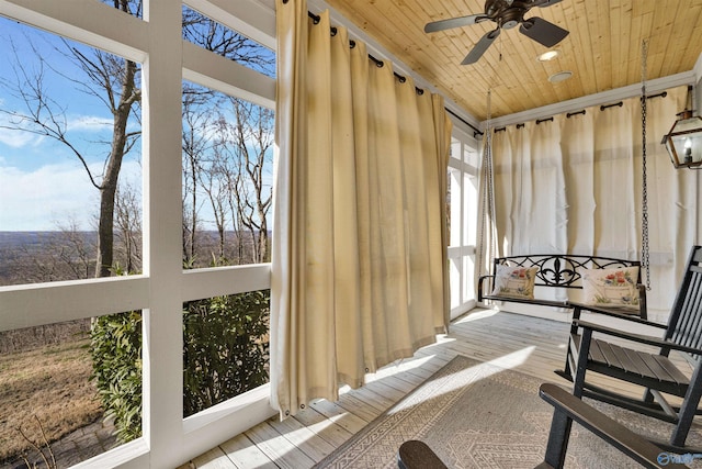 sunroom / solarium featuring ceiling fan, wood ceiling, and a healthy amount of sunlight