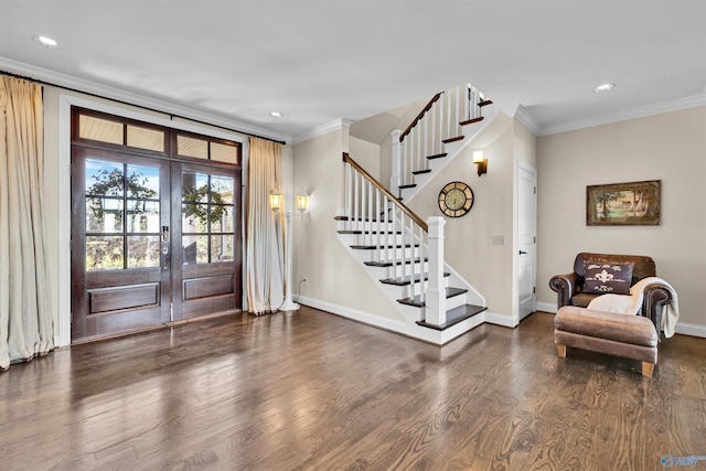 entryway featuring stairway, wood finished floors, baseboards, and ornamental molding