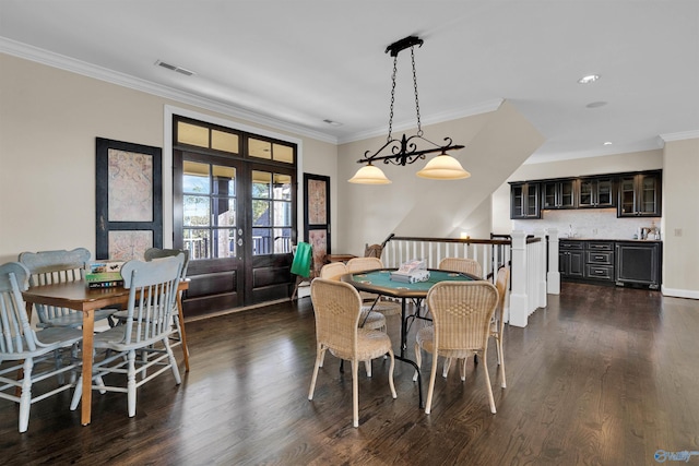 dining room with visible vents, french doors, crown molding, and dark wood-style flooring