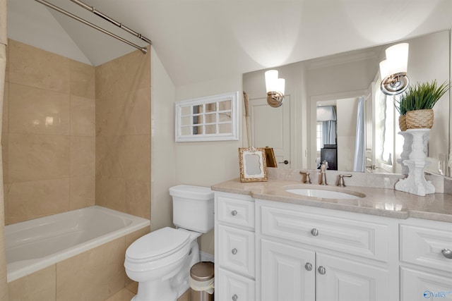 bathroom featuring vanity, vaulted ceiling, toilet, and  shower combination