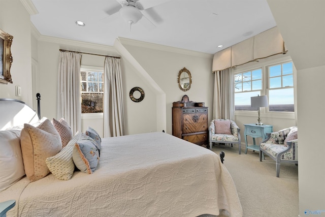 carpeted bedroom featuring ornamental molding and a ceiling fan