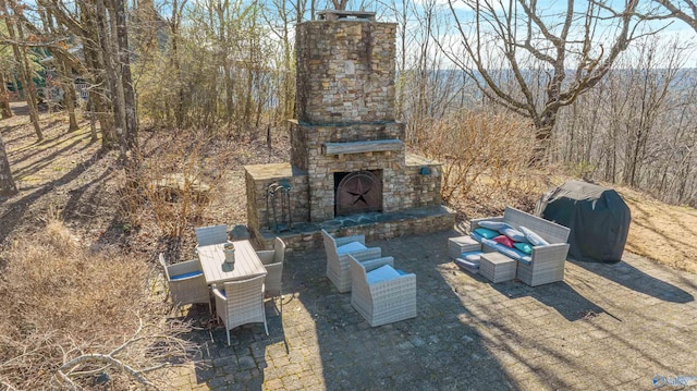 view of patio with grilling area and an outdoor stone fireplace