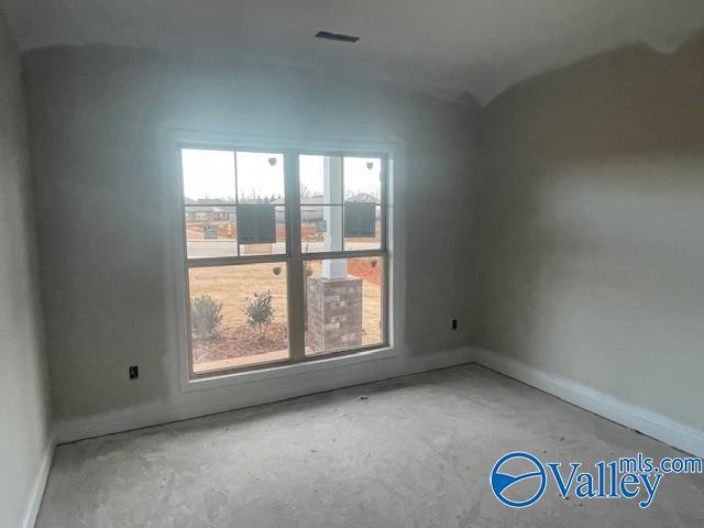 unfurnished room featuring concrete floors