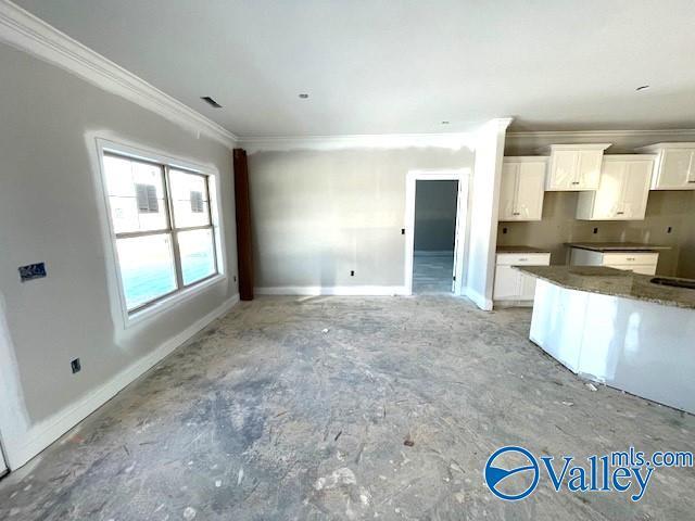 kitchen with white cabinetry and crown molding