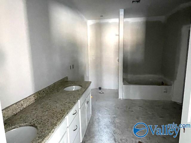 bathroom featuring vanity and concrete flooring