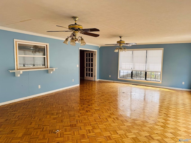 unfurnished room with a textured ceiling, ornamental molding, a ceiling fan, and baseboards