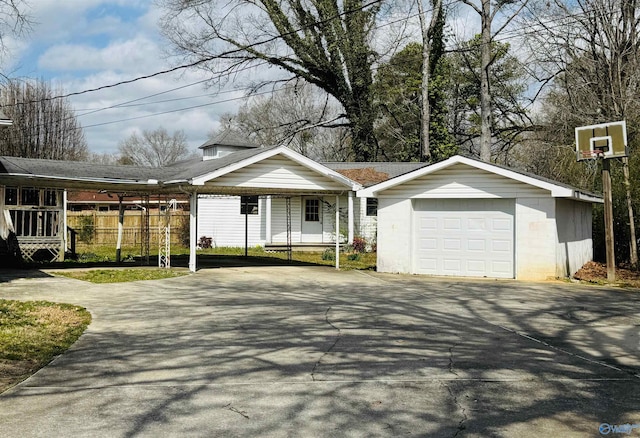 view of front of home with a garage, driveway, and an outdoor structure