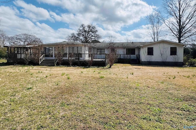 view of front of home with a deck and a front yard