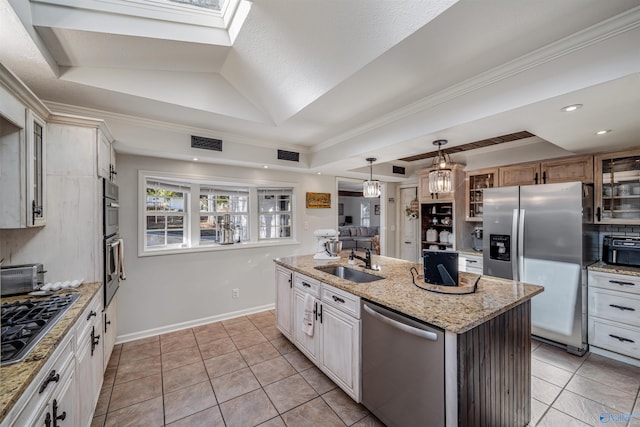 kitchen with white cabinetry, sink, a center island with sink, light tile patterned floors, and appliances with stainless steel finishes