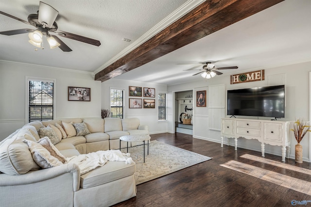 living room with dark hardwood / wood-style flooring, a textured ceiling, ceiling fan, crown molding, and beamed ceiling