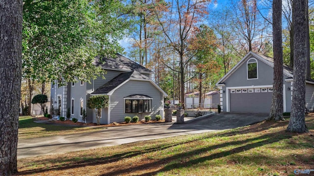 view of side of home with a yard and a garage