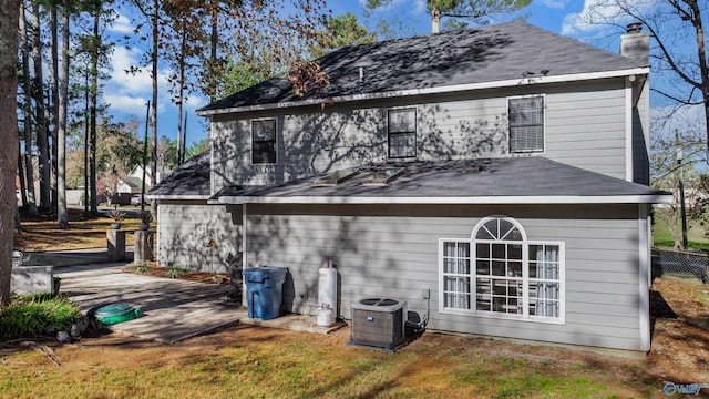 rear view of property featuring central AC unit and a patio