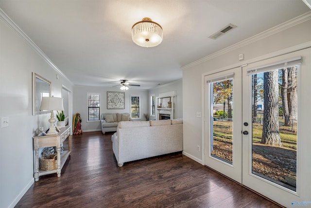 living room with crown molding, dark wood-type flooring, and french doors