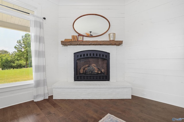 room details featuring a brick fireplace and wood finished floors