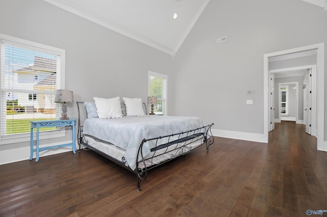 bedroom with multiple windows, dark wood finished floors, visible vents, and baseboards