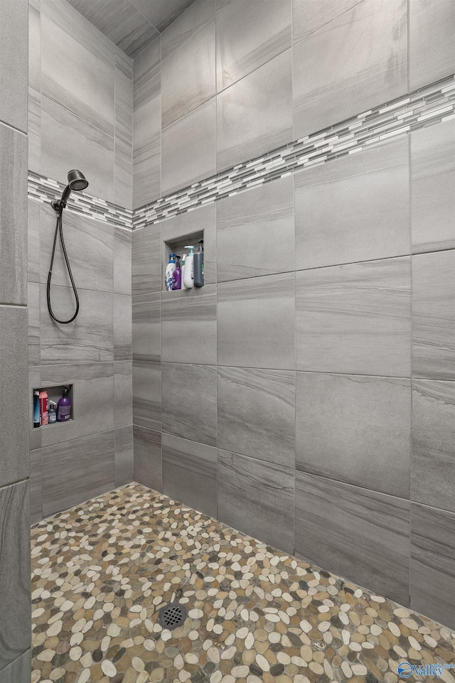 bathroom with a tile shower