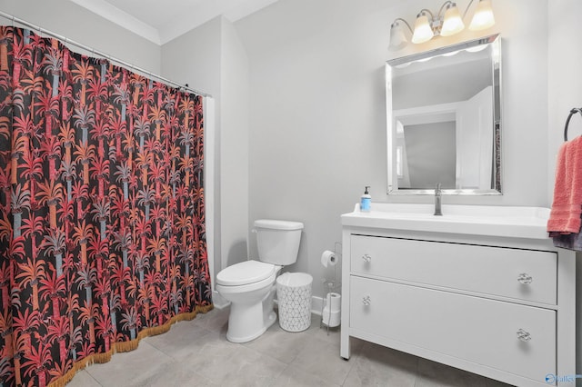 bathroom featuring tile patterned flooring, vanity, toilet, and crown molding