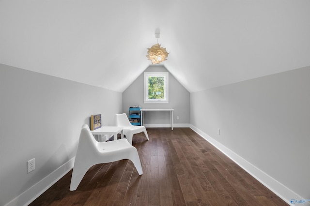 sitting room with vaulted ceiling, baseboards, and dark wood finished floors