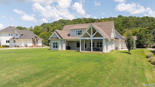 view of front facade with a front yard, a patio area, and central AC unit