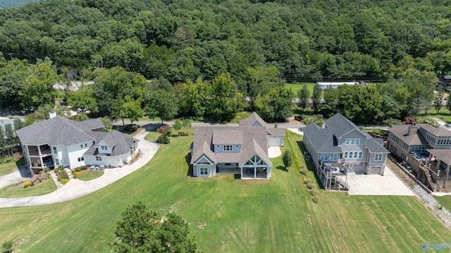 drone / aerial view with a residential view and a wooded view