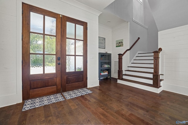 foyer entrance with french doors, dark wood finished floors, and stairway