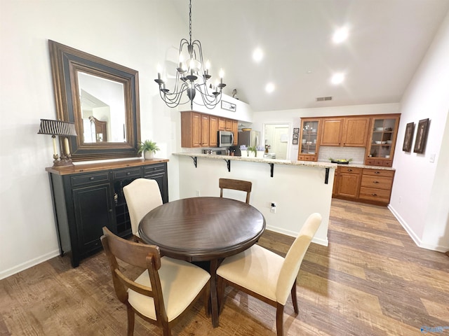 2072 Madison Villas Way Unit 2072, Madison, AL 35758 - dining area with a chandelier, light wood finished floors, baseboards, high vaulted ceiling, and recessed lighting
