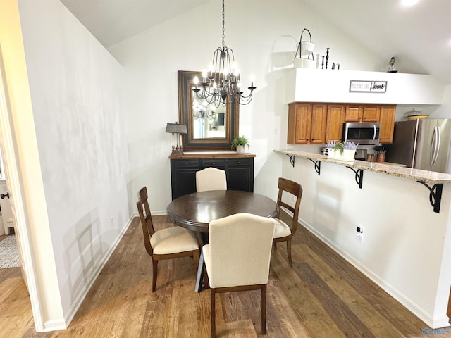 2072 Madison Villas Way Unit 2072, Madison, AL 35758 - dining room featuring wood finished floors, a chandelier, high vaulted ceiling, and baseboards